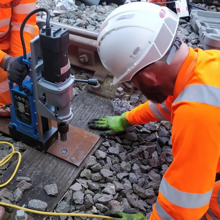SigTech Rail engineer drilling a baseplate trackside